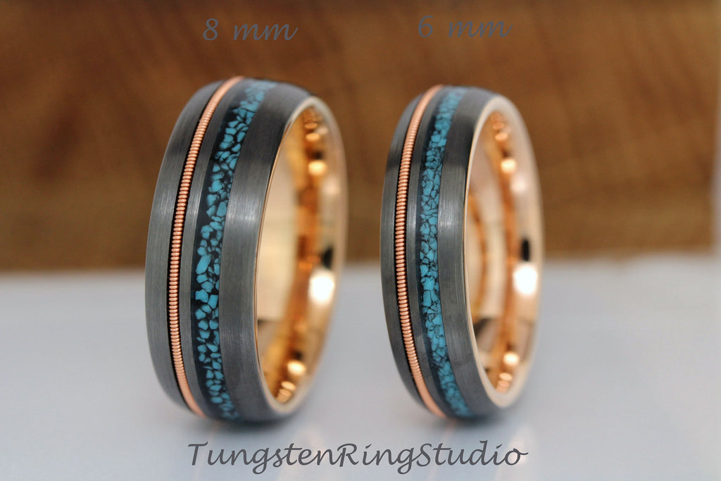 May include: Two tungsten carbide rings with a rose gold inlay and a turquoise inlay. The rings are 8 mm and 6 mm wide.