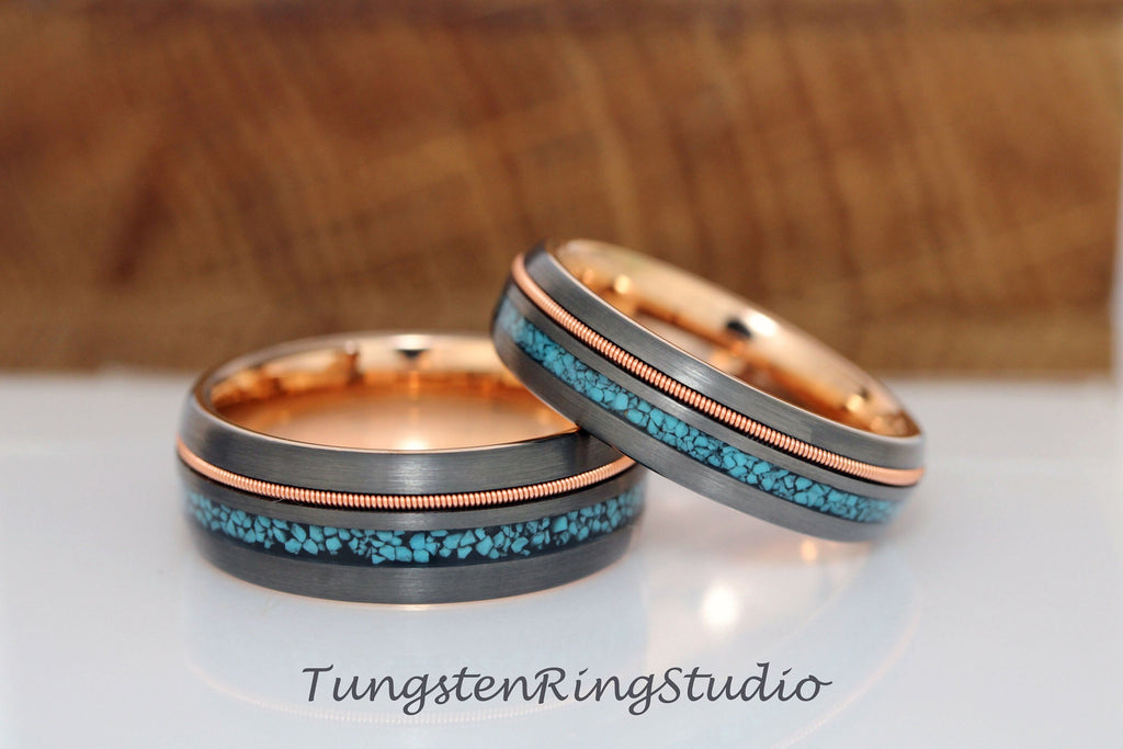May include: Two tungsten carbide wedding bands with a rose gold inlay and turquoise inlay. The bands are both beveled and have a brushed finish.