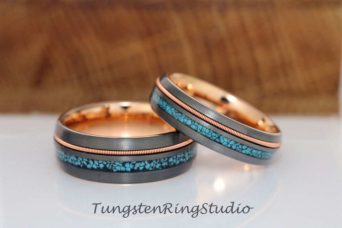 May include: Two tungsten carbide wedding bands with a rose gold inlay and turquoise inlay. The bands are both beveled and have a brushed finish.
