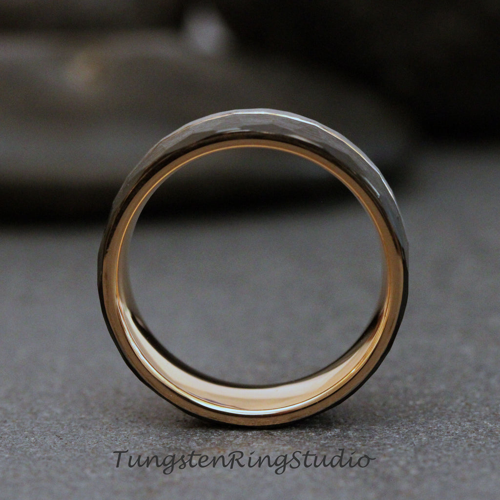 May include: A black tungsten carbide ring with a hammered finish and a gold inner band.