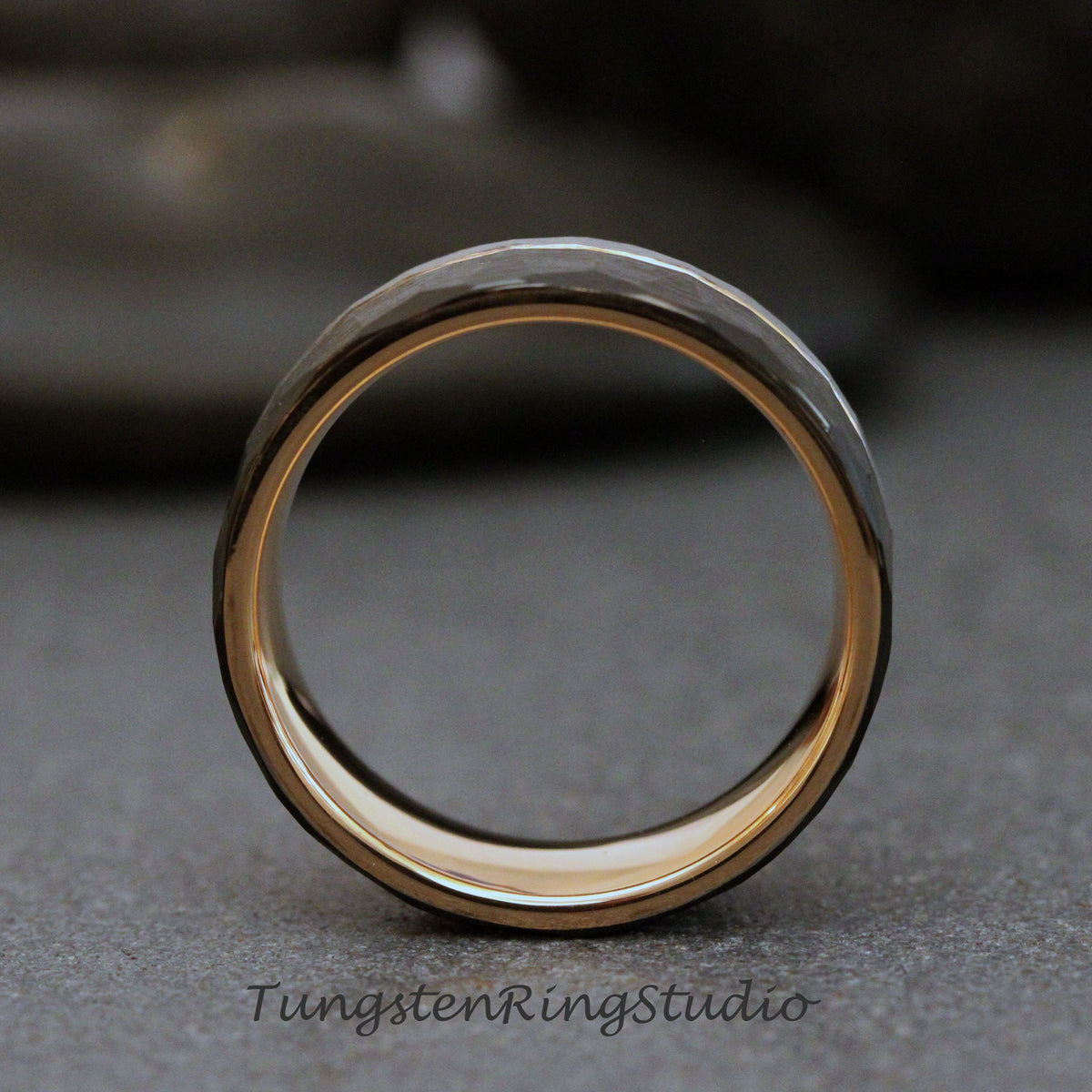 May include: A black tungsten carbide ring with a hammered finish and a gold inner band.