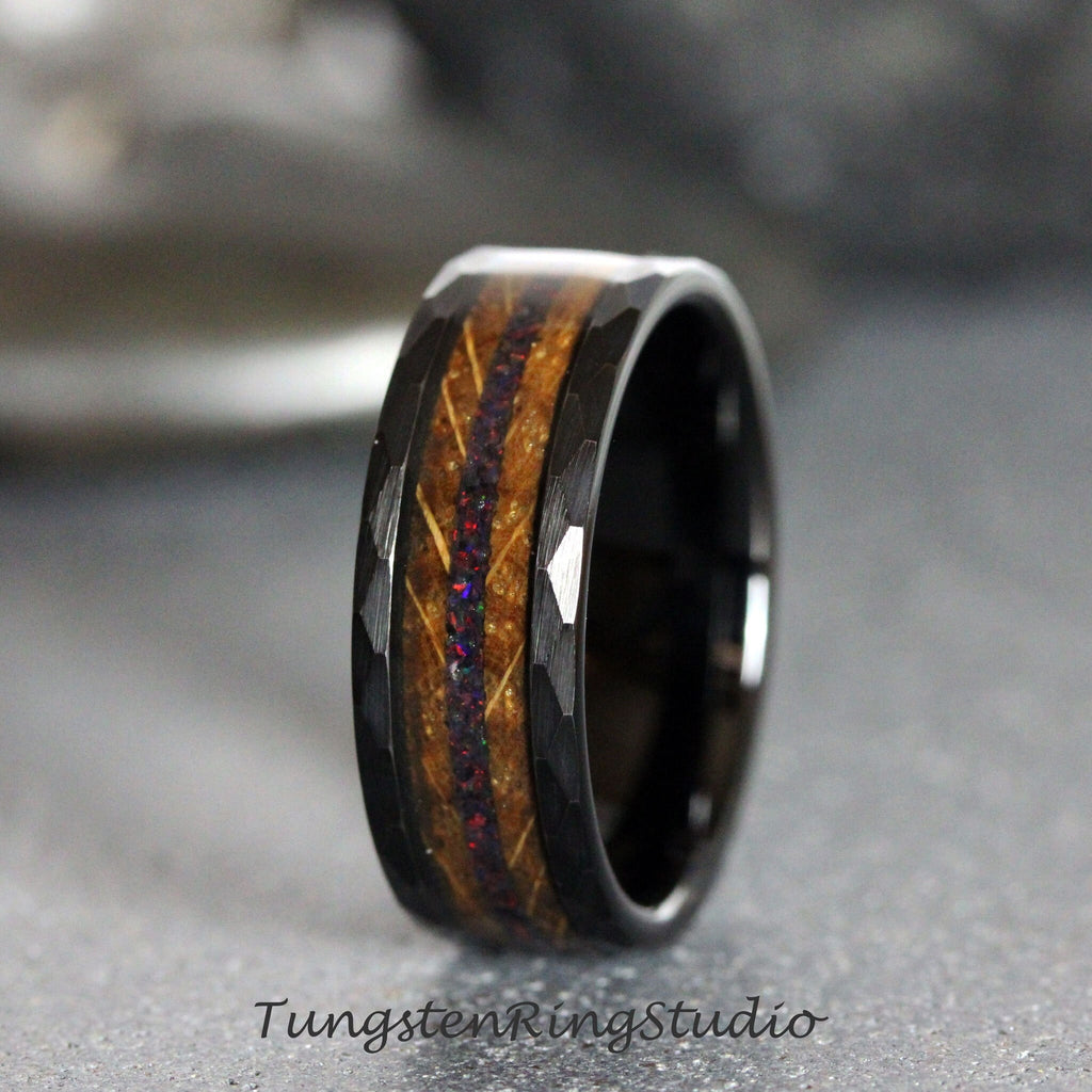 May include: Black tungsten ring with a brown wood inlay and iridescent glitter. The ring has a hammered finish.