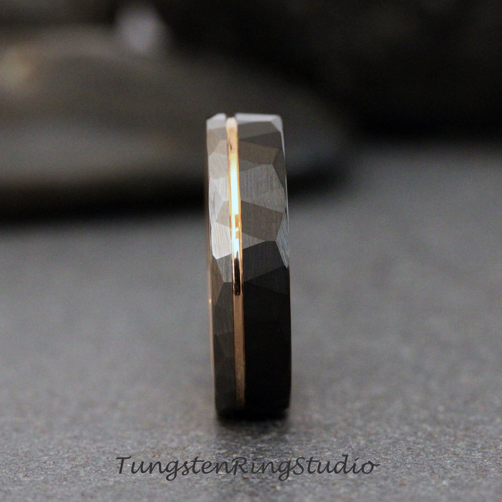 May include: A black tungsten carbide ring with a gold inlay. The ring has a hammered finish and a beveled edge.