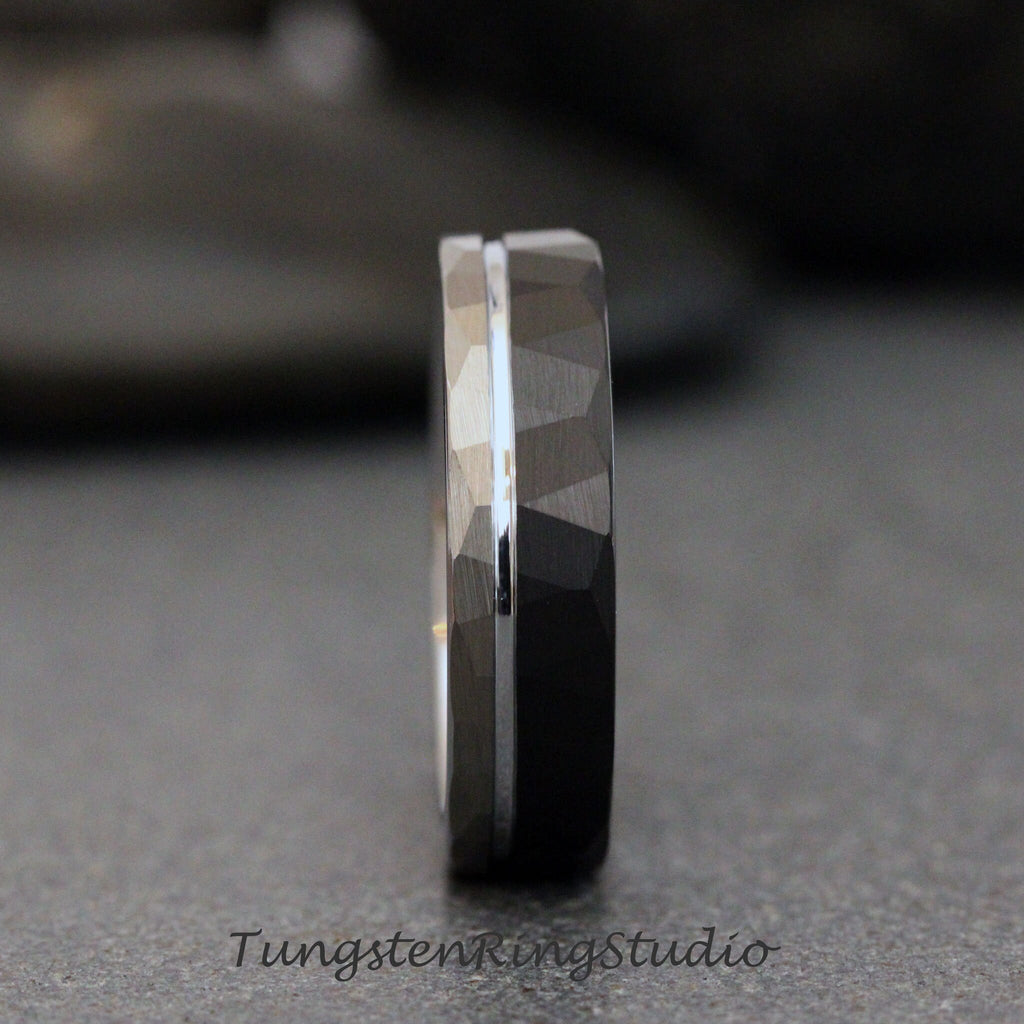 May include: A black tungsten carbide ring with a silver band and a hammered finish.