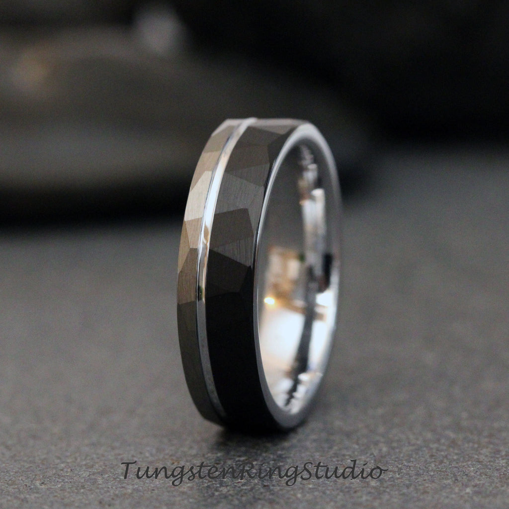 May include: A black tungsten carbide ring with a silver band and a hammered finish. The ring is a popular choice for wedding bands.