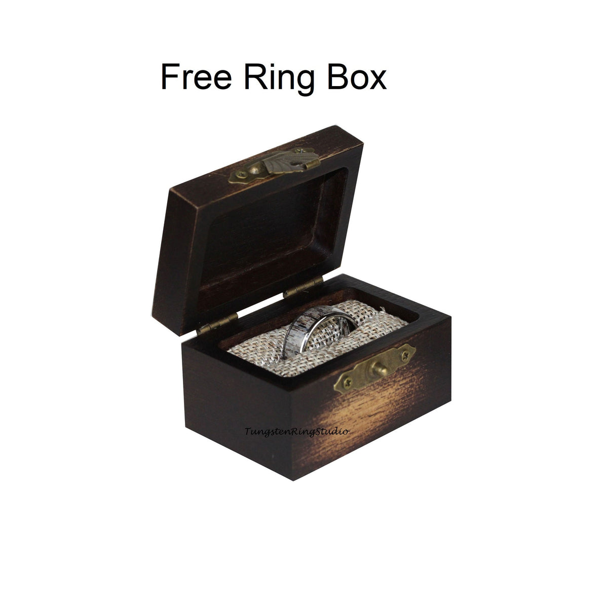 May include: A dark brown wooden ring box with a hinged lid and a brass latch. The box is lined with a beige fabric and contains a silver ring.