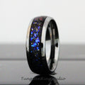 May include: A black tungsten carbide ring with a blue and silver inlay. The ring has a polished finish and a beveled edge.