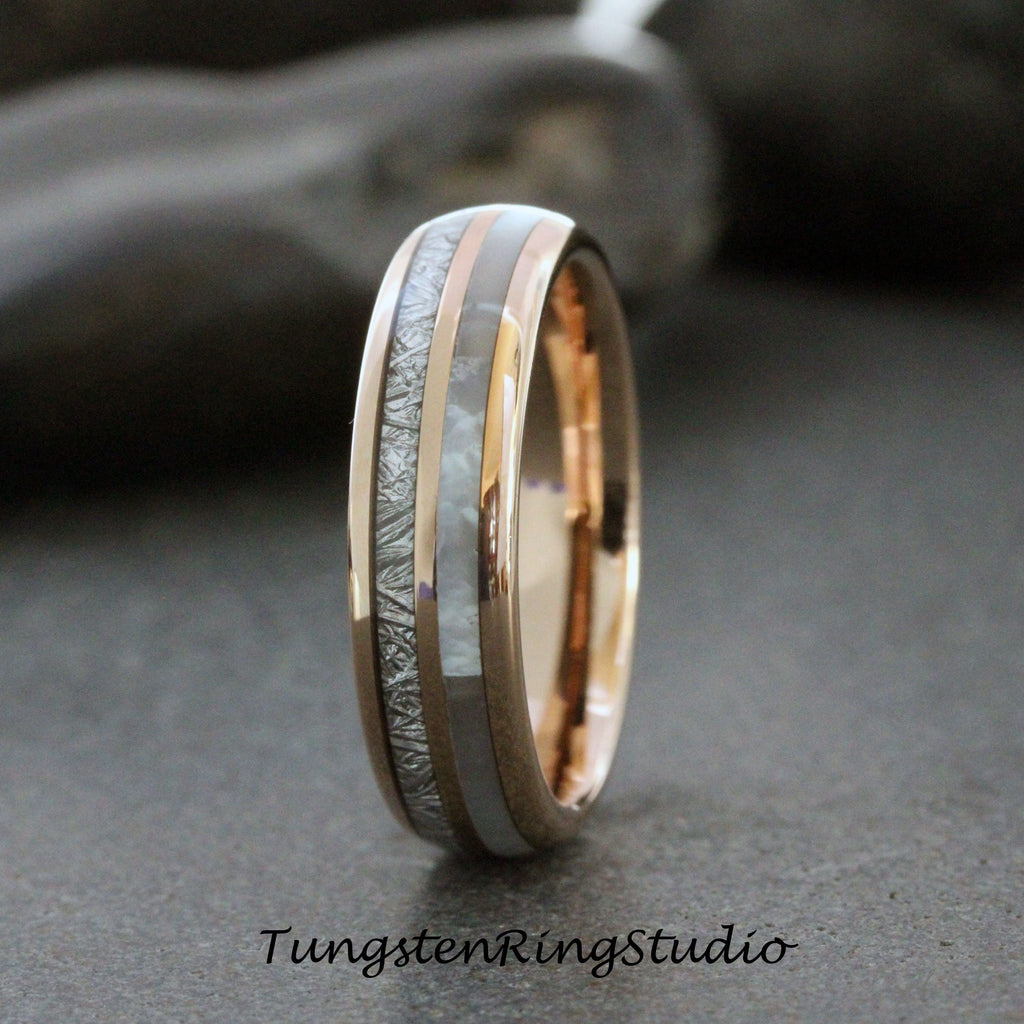 May include: A silver and rose gold tungsten carbide ring with a white inlay and a meteorite pattern. The ring is approximately 6mm wide.