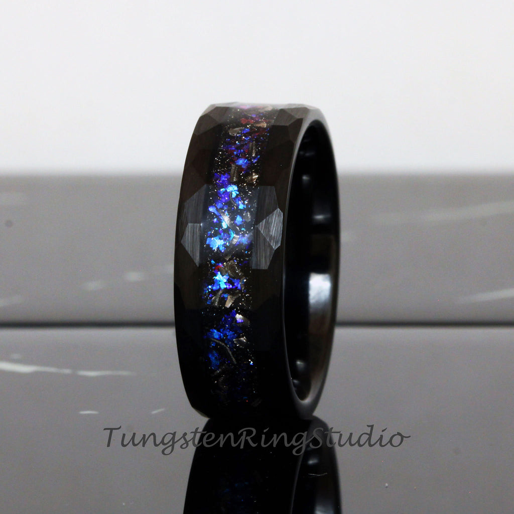 May include: Black tungsten carbide ring with a blue and silver glitter inlay. The ring has a beveled edge and a brushed finish.