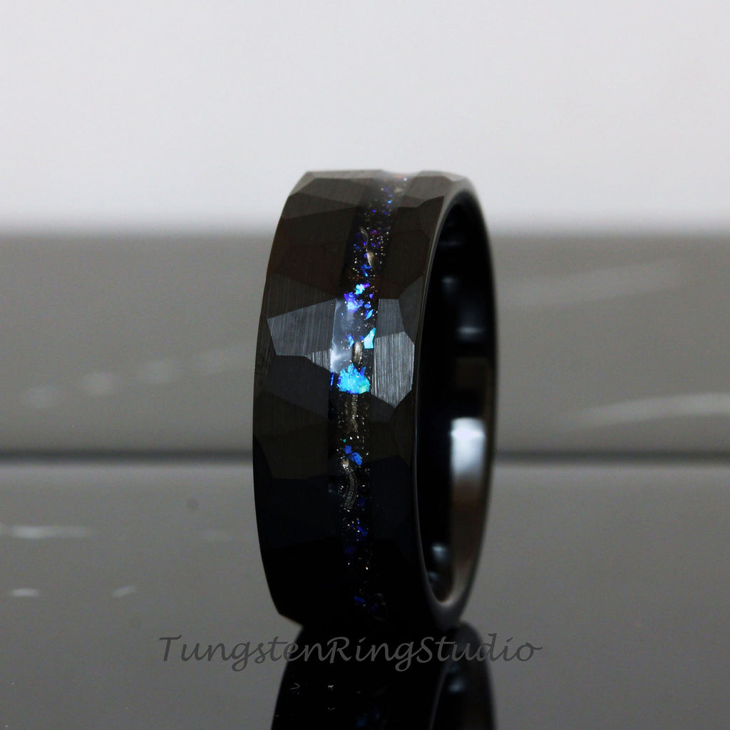 May include: Black tungsten carbide ring with a hammered finish and a blue and silver glitter inlay.