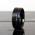 May include: Black tungsten carbide ring with a hammered finish and a thin line of iridescent glitter embedded in the band.