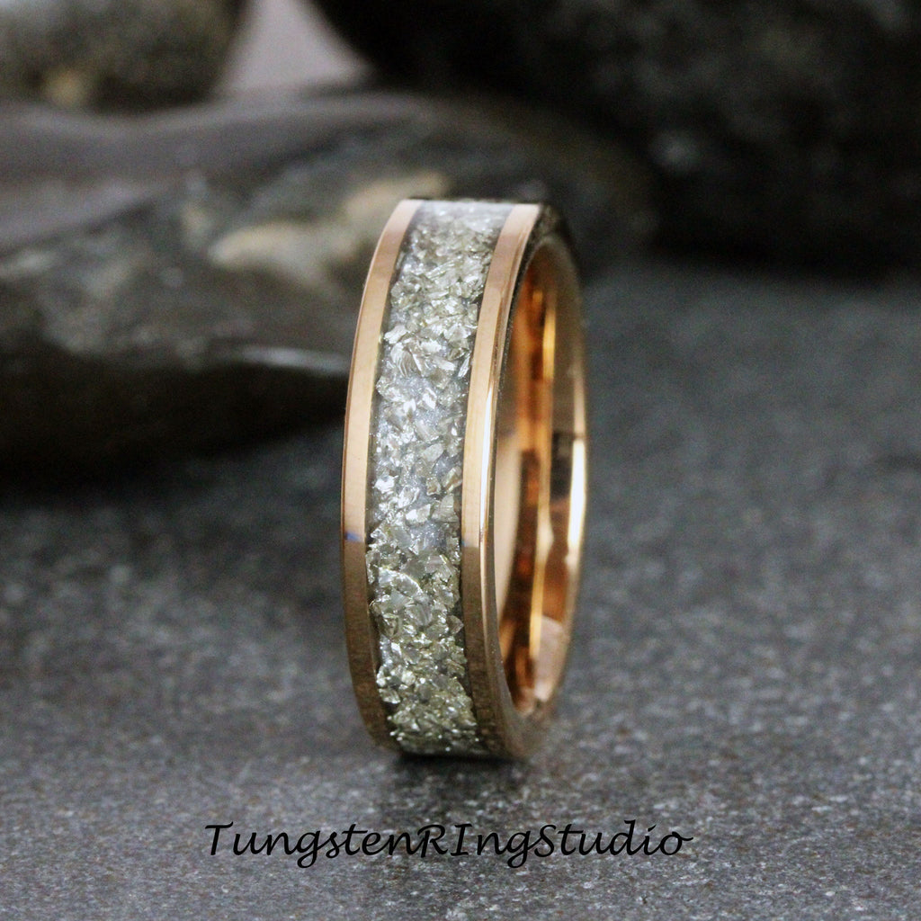 May include: A rose gold tungsten carbide ring with a band of embedded white diamonds.