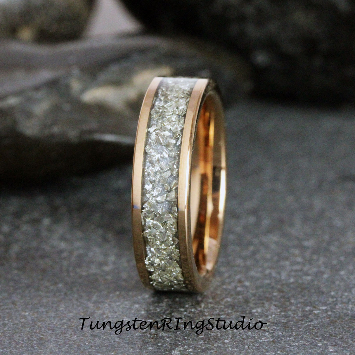 May include: A rose gold tungsten carbide ring with a band of embedded white diamonds.