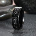 May include: A black tungsten carbide ring with a hammered finish and a thin silver line down the center. The ring has a textured, almost rough, surface.