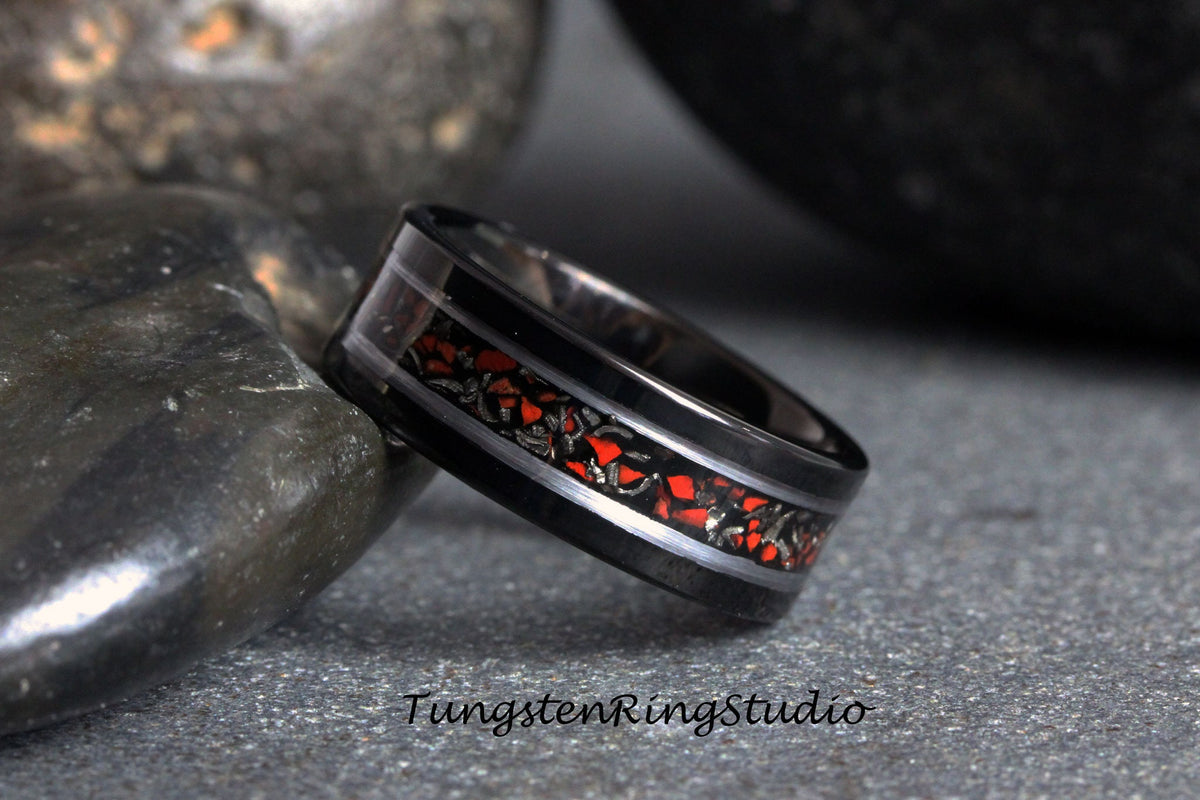 May include: Black tungsten carbide ring with a silver inlay and red and black patterned design. TungstenRingStudio.