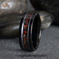 May include: Black tungsten carbide ring with a red and silver inlay. The ring has a polished finish and a beveled edge.