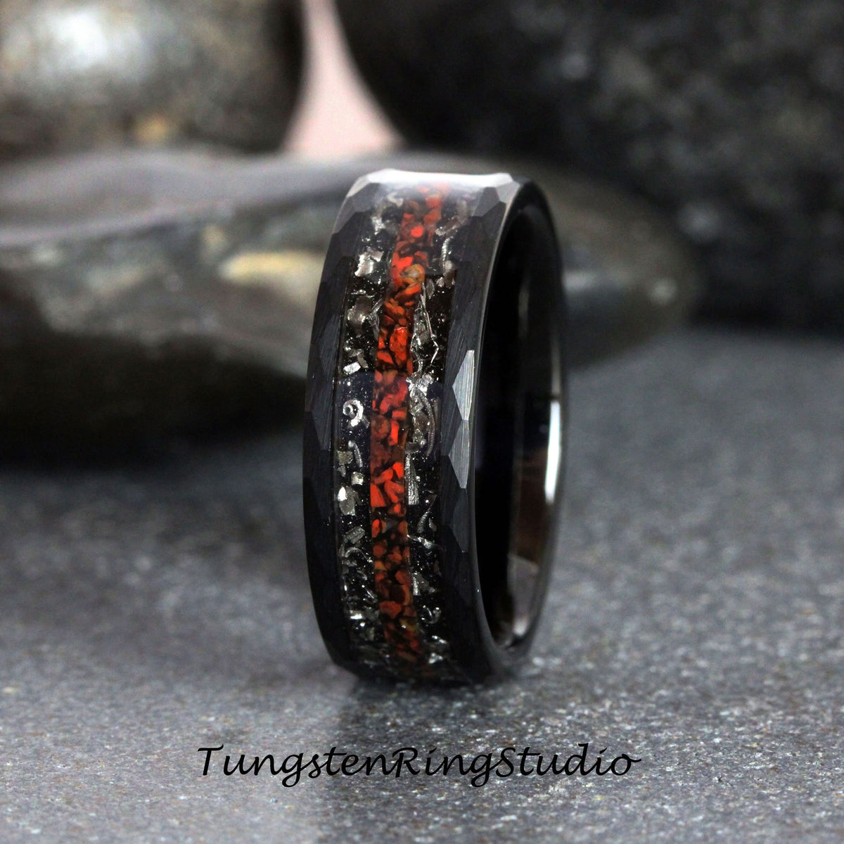 May include: Black tungsten carbide ring with a red and silver inlay. The ring has a hammered finish.