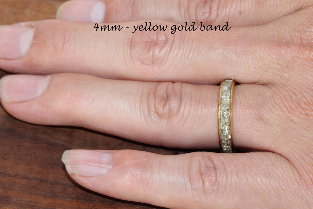 May include: A 4mm yellow gold band with a row of small diamonds around the entire band.