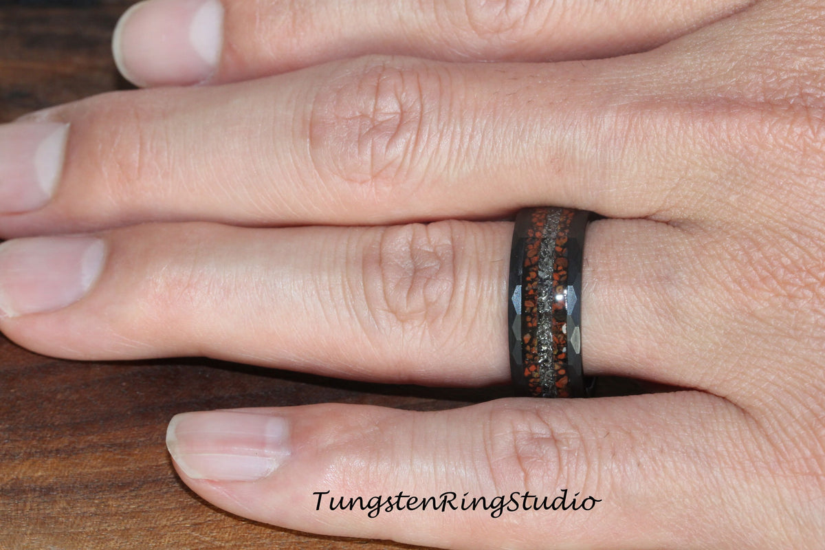May include: A black tungsten ring with a brown and silver inlay. The ring has a beveled edge and a polished finish.