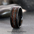 May include: A black tungsten carbide ring with a hammered finish and a red and silver inlay. The inlay is made of crushed stone and is set in a channel around the ring.