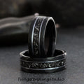 May include: Two black tungsten carbide rings with a hammered finish and a silver inlay. The rings are stacked on top of each other.