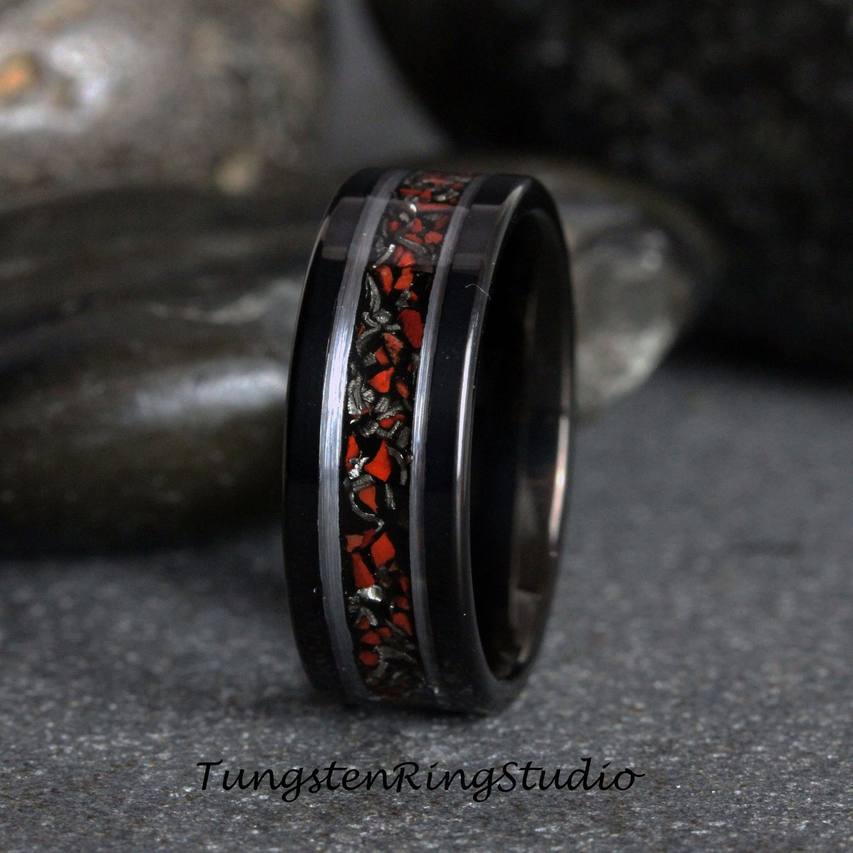 May include: Black tungsten carbide ring with a red and silver inlay. The ring has a polished finish and a comfortable fit.