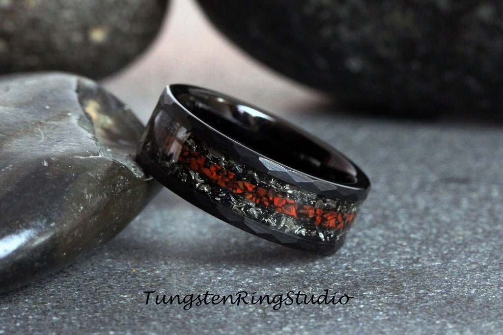 May include: Black tungsten carbide ring with a red and silver inlay. The ring has a beveled edge and a brushed finish.