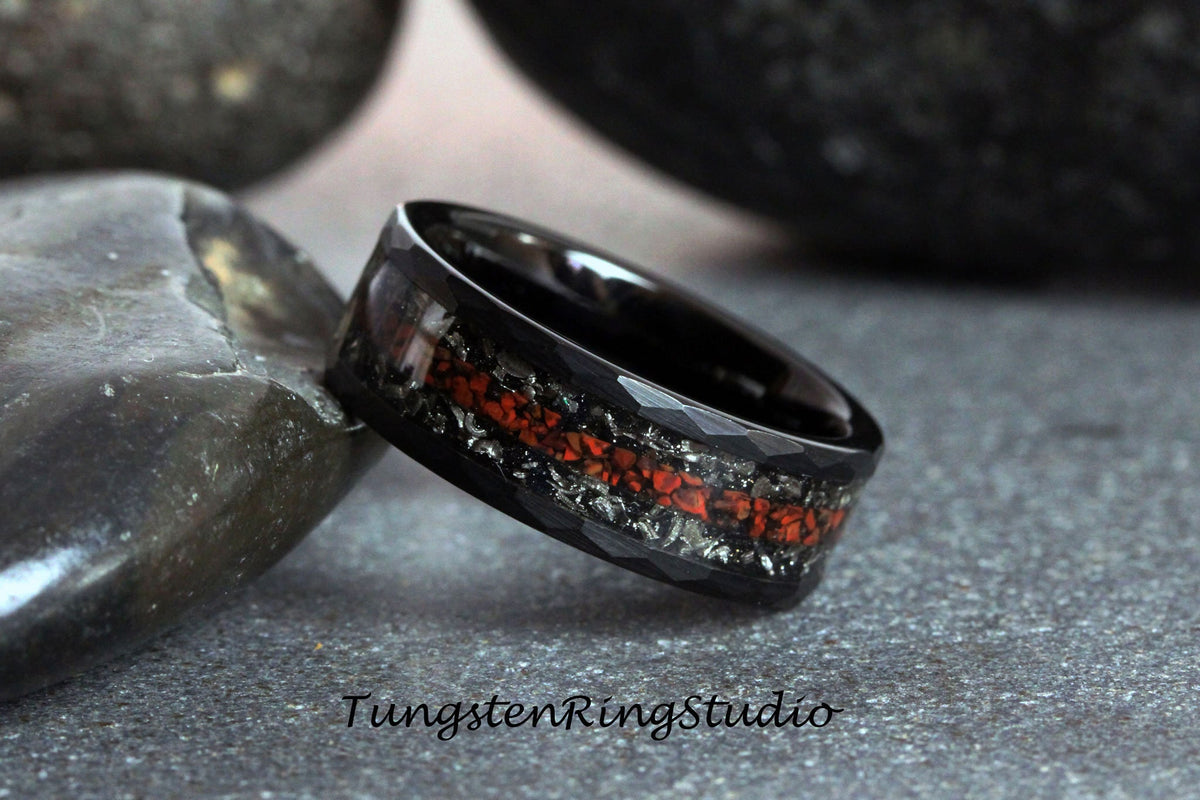May include: Black tungsten carbide ring with a red and silver inlay. The ring has a beveled edge and a brushed finish.