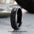 May include: A black tungsten carbide ring with a black diamond inlay. The ring has a brushed finish and a beveled edge.