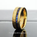 May include: A gold tungsten carbide ring with a hammered finish and a blue and black inlay. The ring is a popular choice for wedding bands.