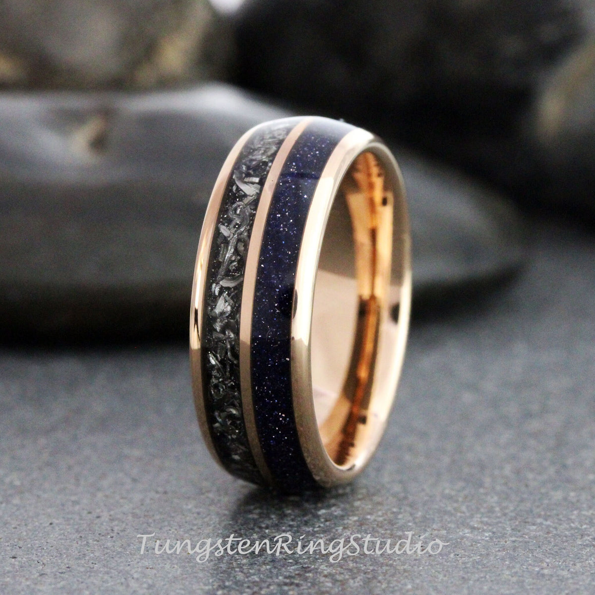 May include: A rose gold tungsten carbide ring with a blue and gray inlay. The ring has a polished finish and a comfortable fit.