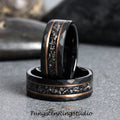 May include: Two black tungsten carbide rings with a hammered finish and a rose gold inlay. The inlay features a scattered pattern of small, silver-colored particles.