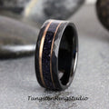 May include: A black tungsten carbide ring with a hammered finish and a rose gold inlay. The inlay features a band of blue glitter.