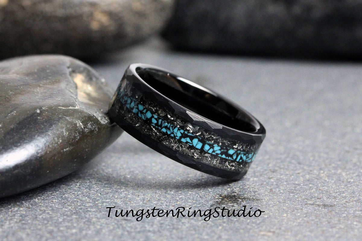 May include: Black tungsten carbide ring with a hammered finish and a turquoise inlay. The inlay is set in a silver-colored metal.