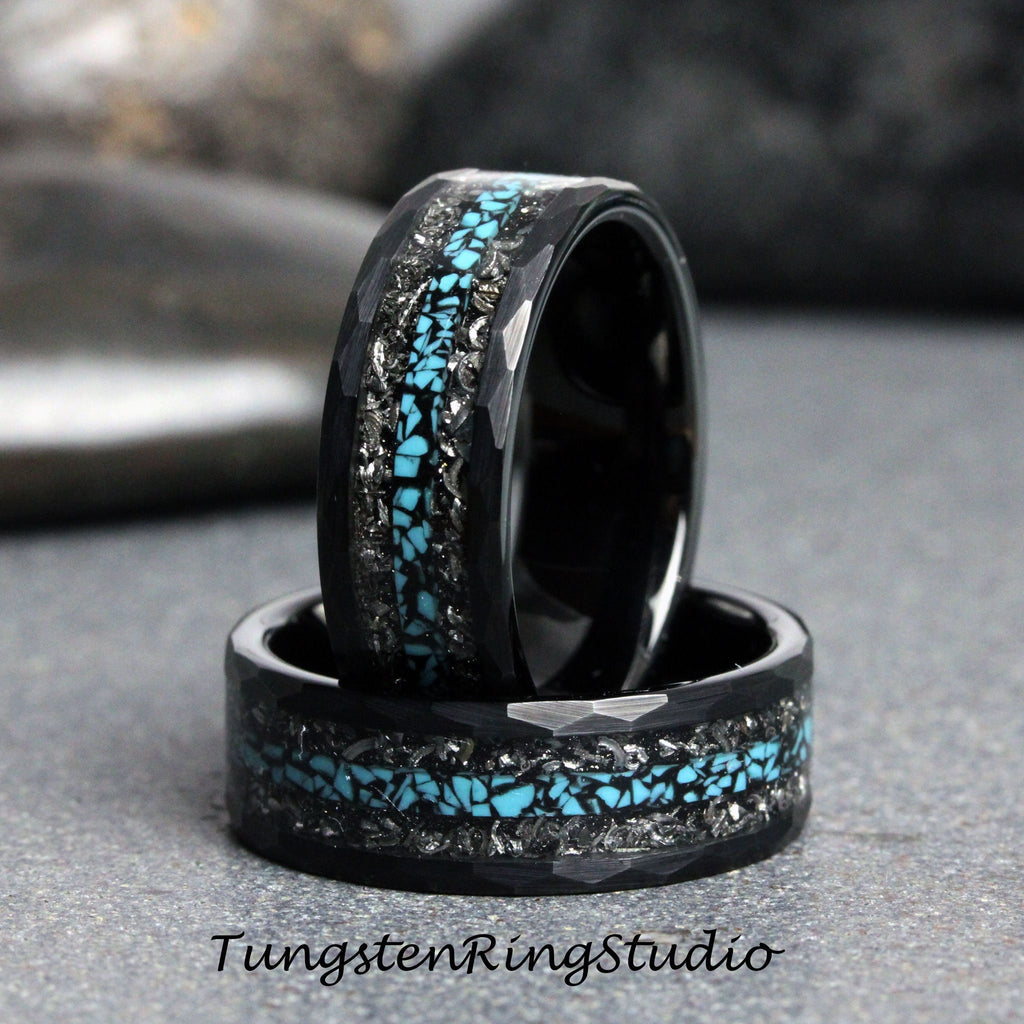 May include: Two black tungsten carbide rings with a hammered finish and a turquoise inlay. The rings are stacked on top of each other.