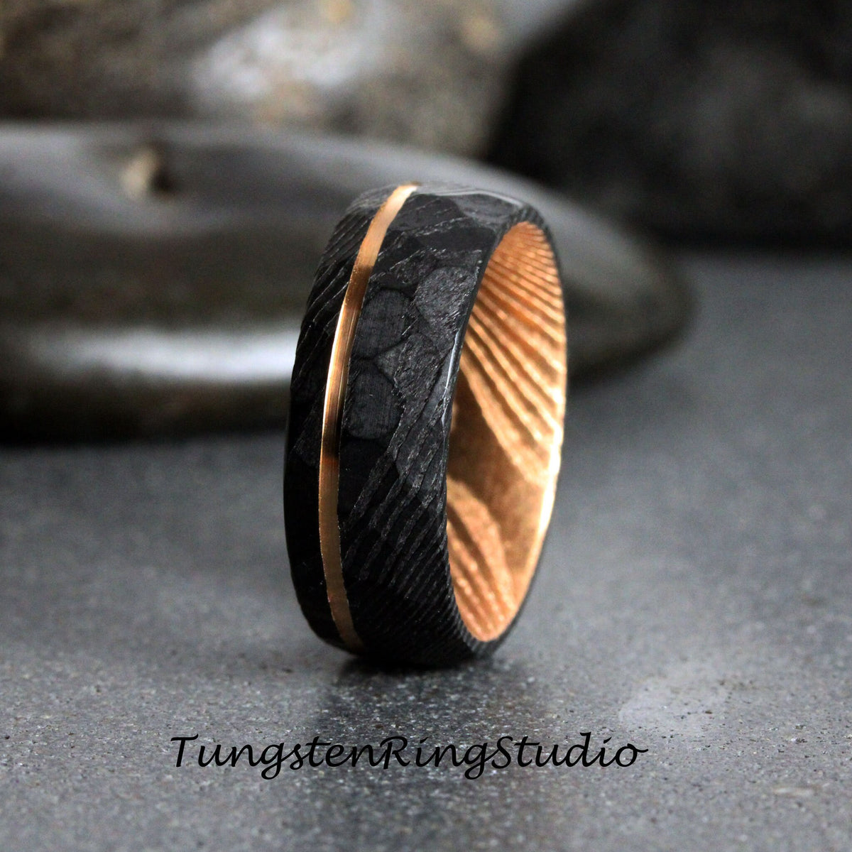 May include: A black tungsten carbide ring with a gold inlay and a wood inlay. The ring has a textured finish.