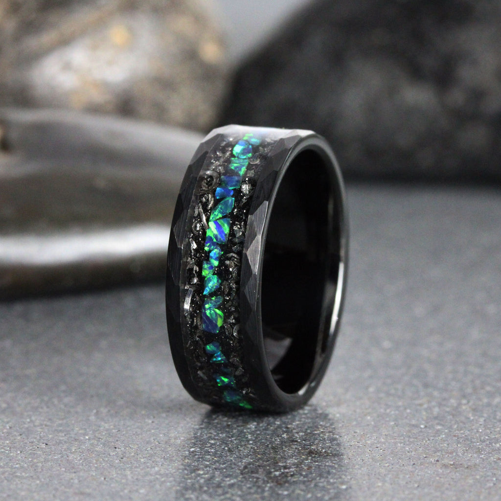 May include: A black tungsten carbide ring with a hammered finish and a band of green and blue opal inlay.