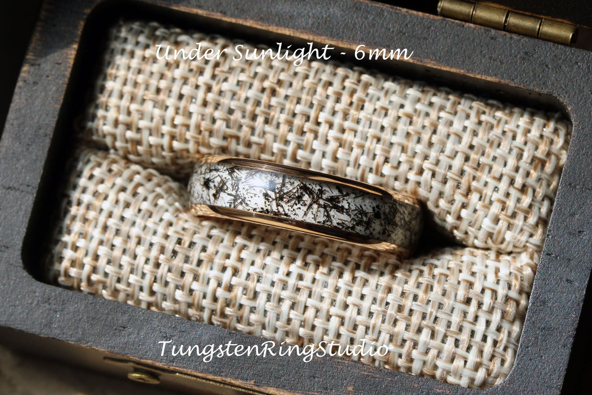May include: A tungsten carbide ring with a black and white inlay design. The ring is 6mm wide and is displayed in a wooden box with a beige fabric lining. "Under Sunlight - 6mm" and "TungstenRingStudio" are printed on the box.