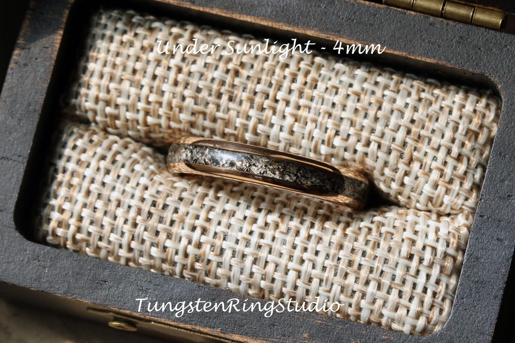 May include: A close-up of a 4mm wide tungsten carbide ring with a black and grey inlay. The ring is in a small wooden box lined with burlap fabric. The text "Under Sunlight - 4mm" and "TungstenRingStudio" are visible in the image.