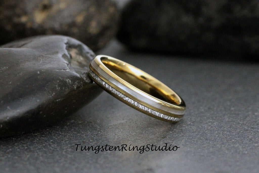 May include: A gold and silver tungsten carbide ring with a hammered finish. The ring has a thin white band with a textured surface.