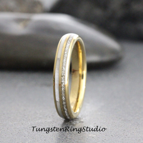 May include: A gold and white tungsten carbide ring with a thin band of white inlay. The ring has a brushed finish.