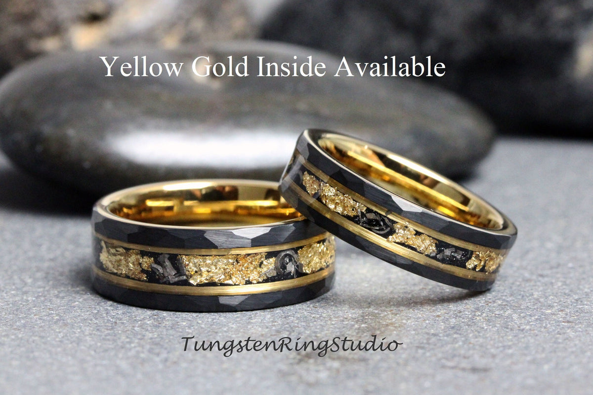 May include: Two black tungsten carbide rings with a gold inlay. The rings have a hammered finish and are set against a gray background. The text "Yellow Gold Inside Available" is displayed above the rings.