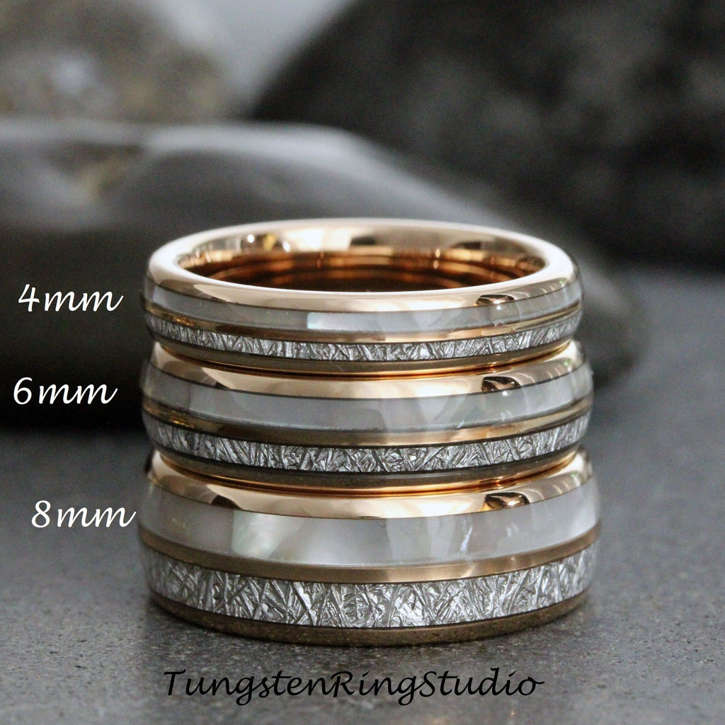 May include: Three tungsten carbide rings with a rose gold finish and a white mother-of-pearl inlay. The rings are stacked on top of each other, with the smallest ring at the top and the largest ring at the bottom. The rings are 4mm, 6mm, and 8mm wide.