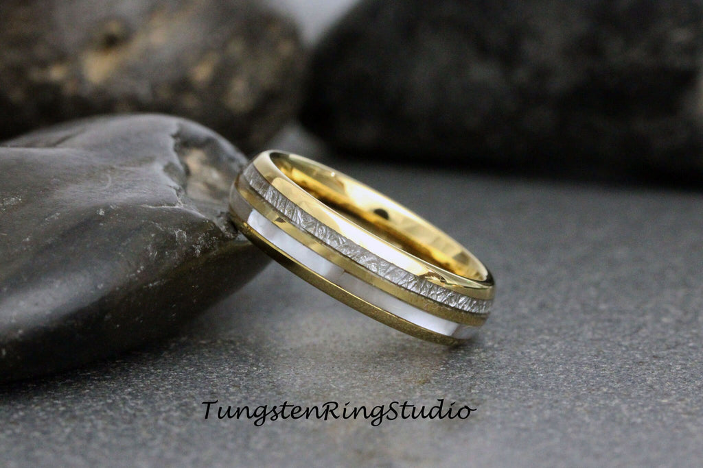 May include: A gold and silver tungsten carbide ring with a white inlay and a textured silver band. TungstenRingsStudio.