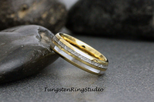 May include: A gold and silver tungsten carbide ring with a white inlay and a textured silver band. TungstenRingsStudio.