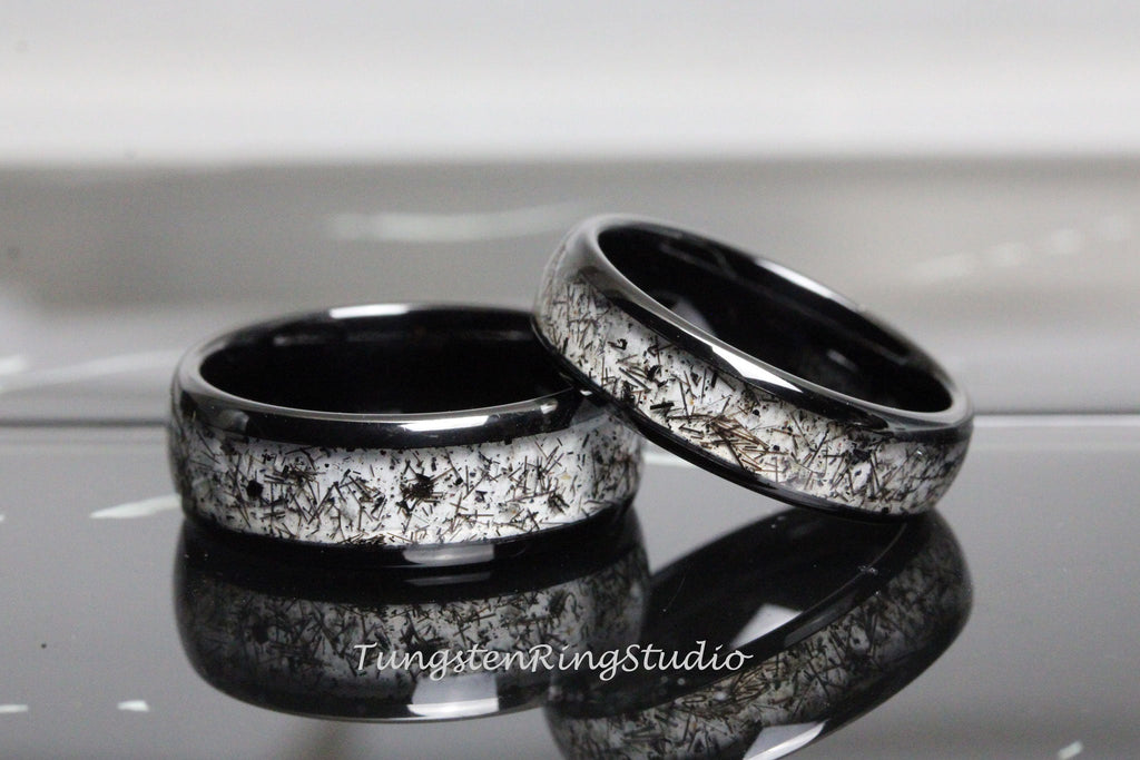 May include: Two black tungsten carbide rings with a white, speckled, and textured finish. The rings are stacked on top of each other.