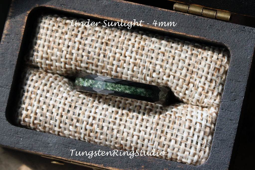 May include: A black tungsten ring with a green inlay, 4mm wide, in a wooden box with a brown fabric lining. The text "Under Sunlight - 4mm" is visible on the box.