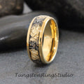 May include: A gold tungsten carbide ring with a black inlay featuring gold flecks. The ring has a polished finish.