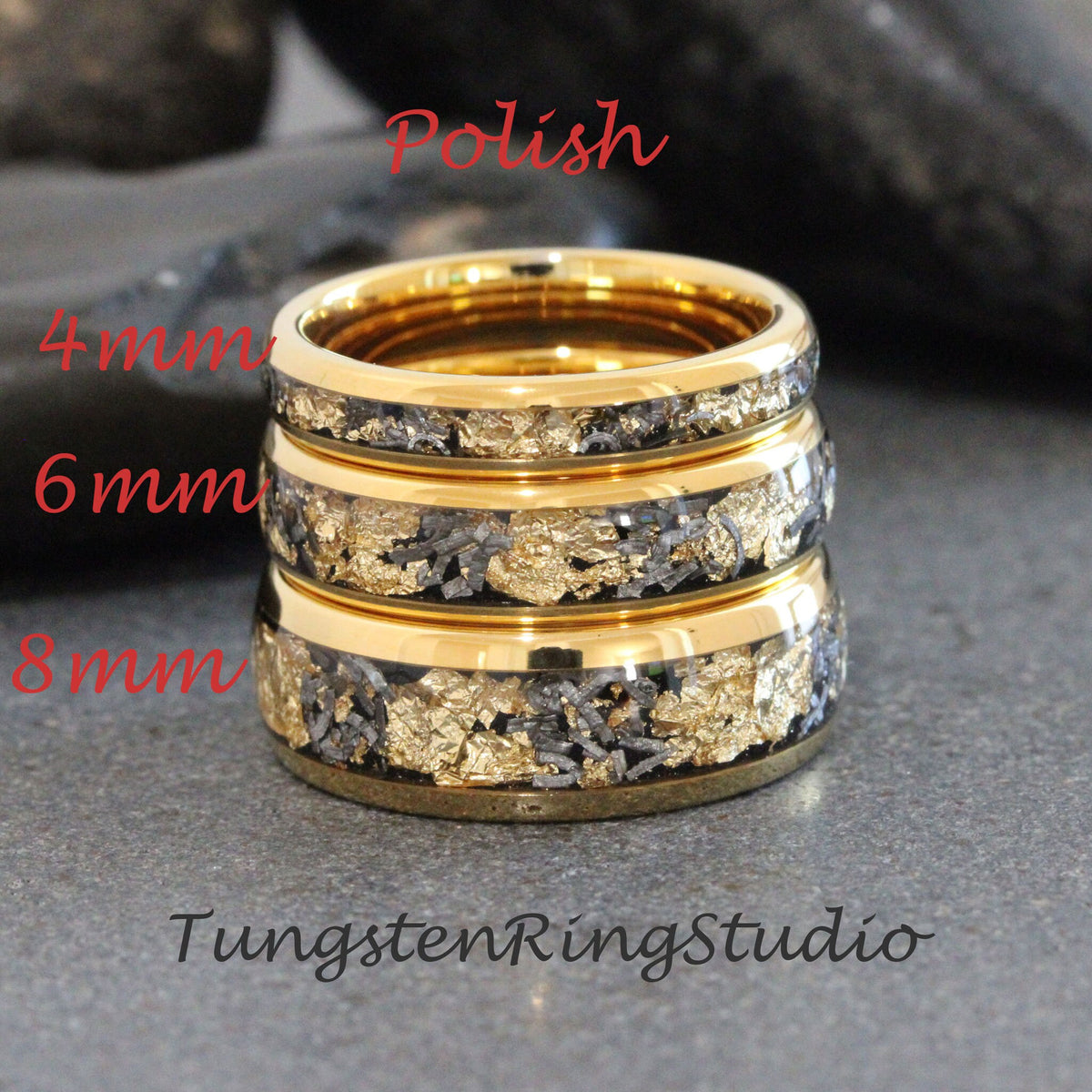May include: Three gold tungsten carbide rings with black and gold inlay. The rings are stacked on top of each other, with the smallest ring on top. The rings are labeled with their sizes: 4mm, 6mm, and 8mm. The text "Polish" is above the rings, and the text "TungstenRingStudio" is below the rings.
