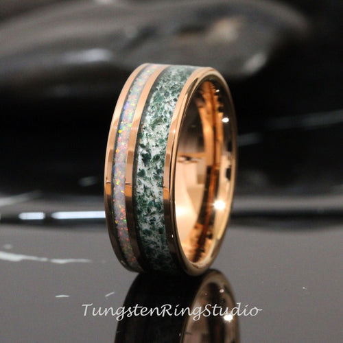 May include: A tungsten carbide ring with a green and white inlay and a rose gold finish.
